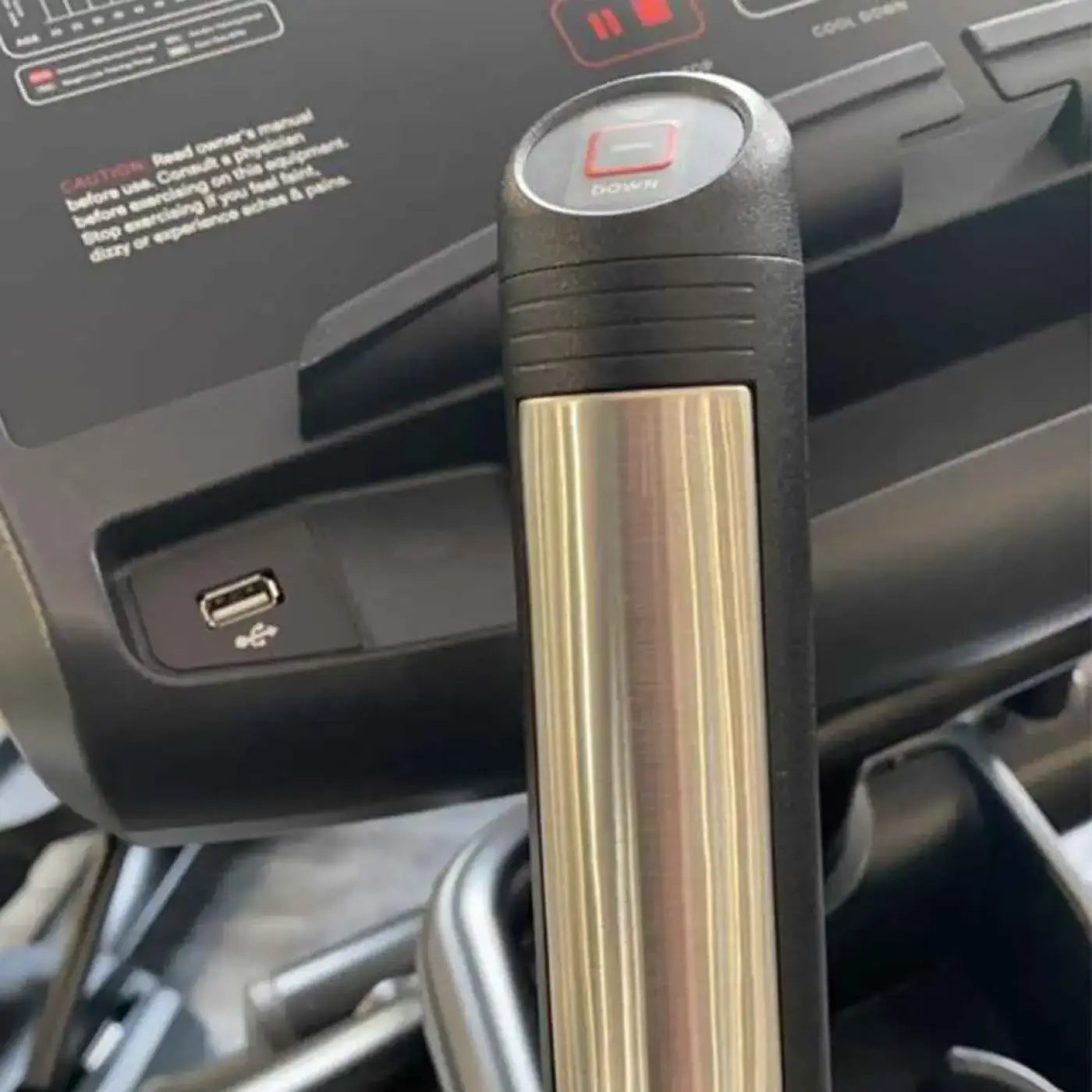 Black and gold-toned treadmill resistance handle with red down button on gym gear X98s sport cross trainer elliptical UK model