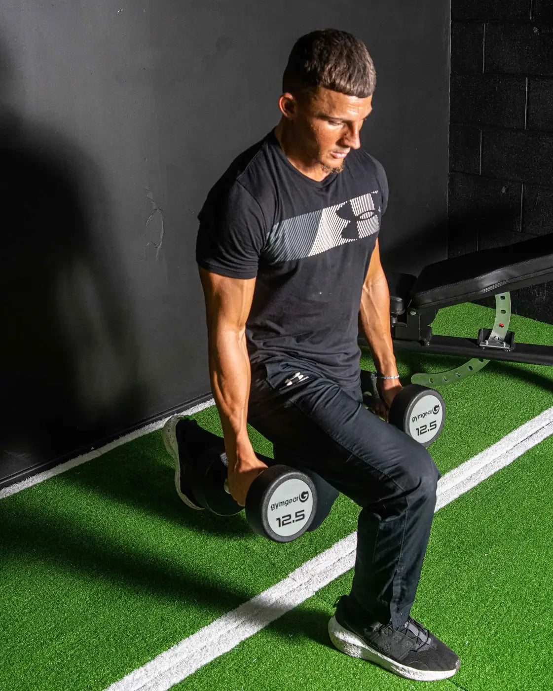 Black urethane dumbbells set for home training with white 12.5 weight markings and silver logo on end caps