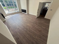 Gray wood-effect premium laminate flooring tiles 20mm thick with realistic grain pattern for home gyms