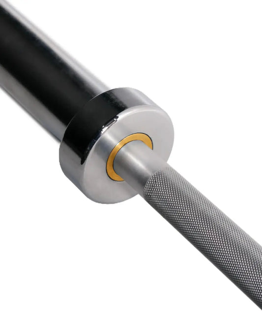 Black and silver 6ft olympic aluminium technique barbell with textured grip and gold collar for home fitness use