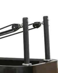 Black metal poles with circular end caps on the back side of aluminium pilates reformer for uk delivery