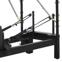 Aluminium reformer with tower system half trapeze featuring black metal frame silver resistance bands and yellow hooks for home workout