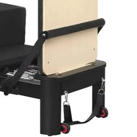 Aluminium reformer with tower system half trapeze in black with beige sliding carriage and red-accented wheels for home workout