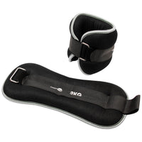 Black ankle weights with silver straps on a white background