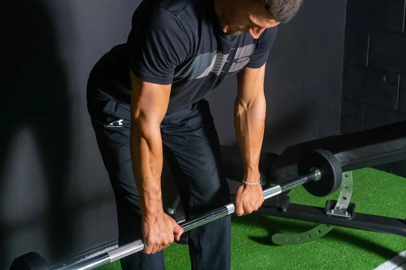 Black under armour t-shirt with white diagonal stripe pattern featured with fixed rubber barbell sets uk delivery
