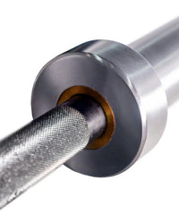 Silver gym gear elite 7ft olympic barbell with textured grip and gold-colored collar for home use