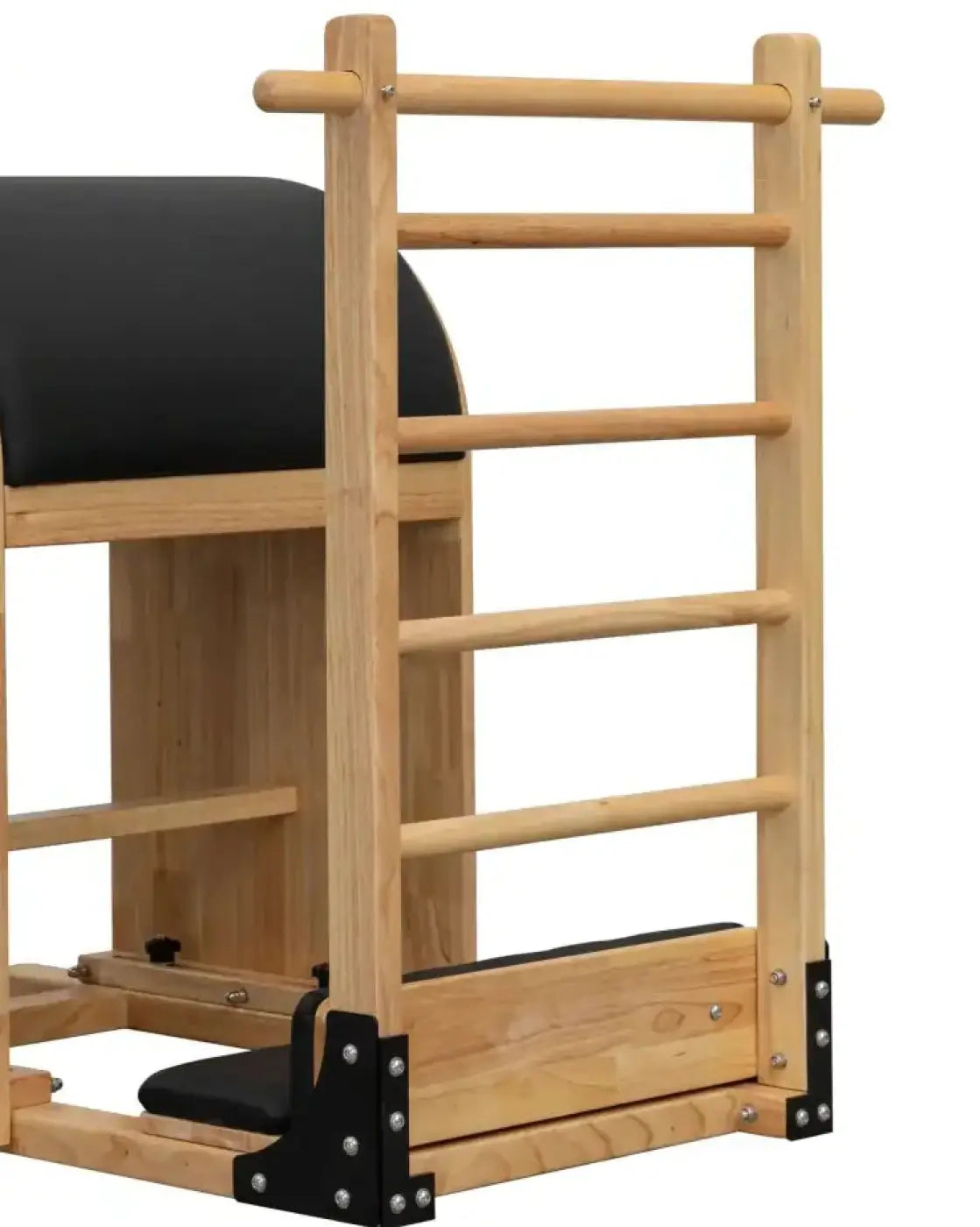 Light-colored wooden pilates reformer with black padded surfaces and metal hardware for space-saving gym gear ladder barrel