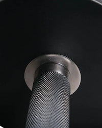 Black rubber dumbbell with textured matte grip and polished metallic collar for home fitness by Gym Gear Pro