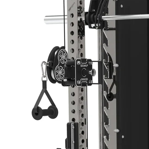 Close-up of a power rack attachment with a black cable pulley system and dual wheels, mounted on a silver and black strength training machine. The attachment features a black plate with silver hardware and a black handlebar pull tab.