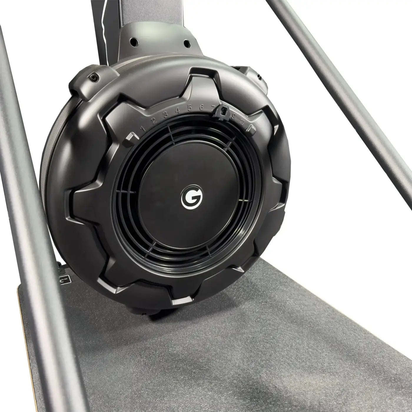 Black circular speaker with rugged textured casing and central logo featured on gym gear ski max 2.0 ski erg machine