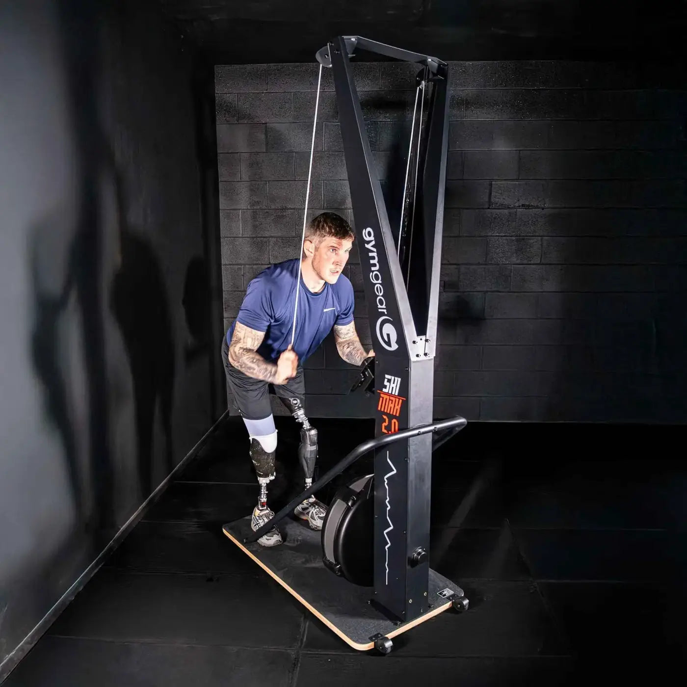 A man using a black gymgear shi trx 2.0 cable machine in a gym setting for home fitness in the UK