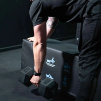Black hexagonal dumbbell displayed with gym gear soft plyometric bench for uk delivery fitness use