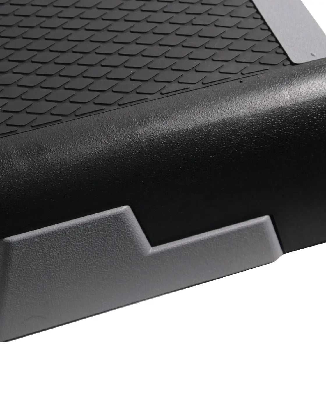 Black rubberized Gym Gear Studio aerobic step with textured diamond grip surface and reinforced side edges for home gym use