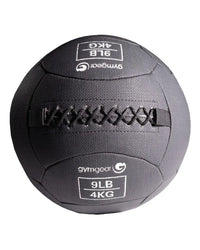 Dark gray fabric Gym Gear wall ball with black stitched straps and white branding for home gym workouts