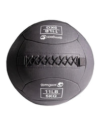 Dark gray gym gear wall ball medicine ball with stitched fabric and reinforced strap for home gym use weighing 11lb 5kg