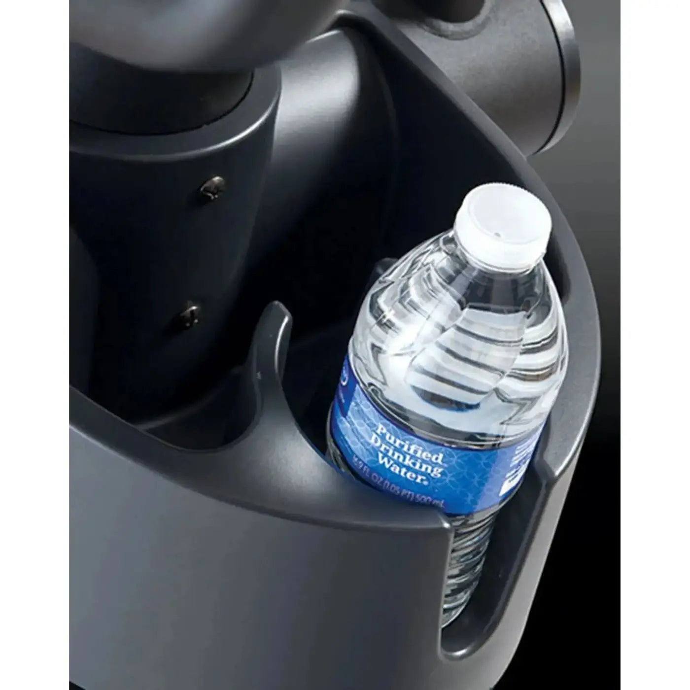 A clear plastic purified drinking water bottle with white cap and blue label in a dark gray car cup holder of Gym Gear X98e cross trainer