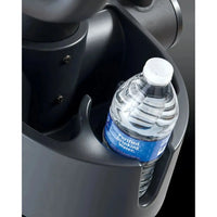 A clear plastic purified drinking water bottle with white cap and blue label in a dark gray car cup holder of Gym Gear X98e cross trainer