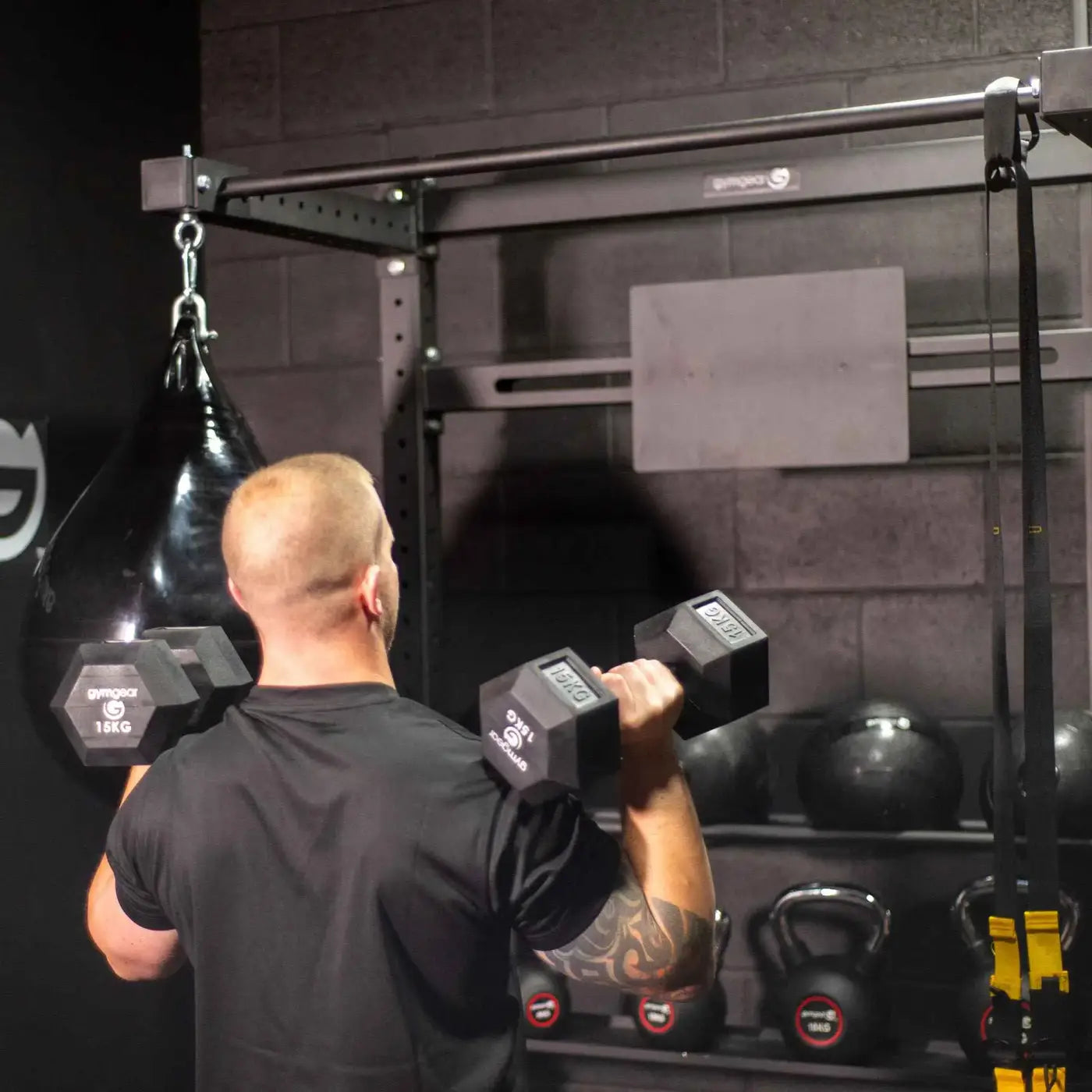 Black hexagonal gymnova dumbbells with 15kg weight markings for hiitmax training station home gyms