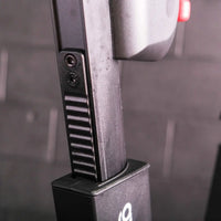 Black textured grip with screws and ridges mounted on a matching black base of m sport elite upright exercise bike rear side