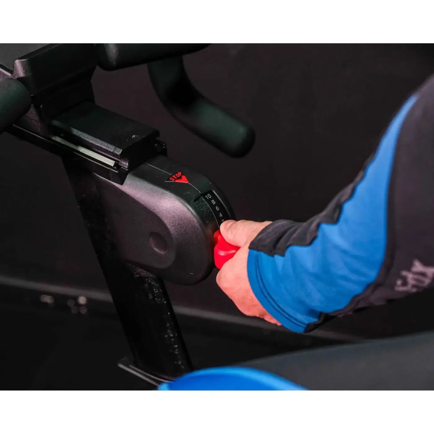 Red emergency stop button on black console of m sport elite upright exercise bike for home gym uk use