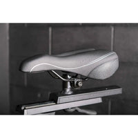 Silver textured perforated bicycle saddle with white stitching on the m sport elite upright exercise bike uk model
