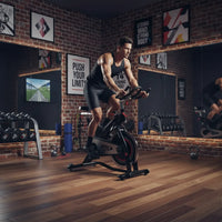 Black and red m sport indoor studio stationary bike with digital display screen for home workouts