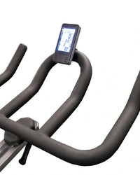 Black ergonomic handlebars with digital display mounted on top on m sport spl indoor cycle compact design front view