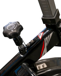 Black star-shaped adjustment knob with white press and arrows on glossy black frame of m sport spl indoor cycle compact design