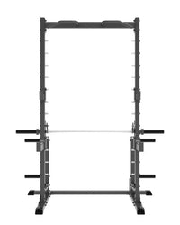 Black metal Pro Series plate loaded half cage Smith machine with adjustable safety bars and barbell on lower shelf for home workout