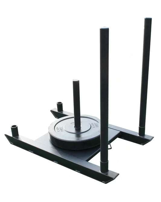 Black metal power rack with three vertical bars and a circular weight plate mounted on its base for prowler sled UK delivery