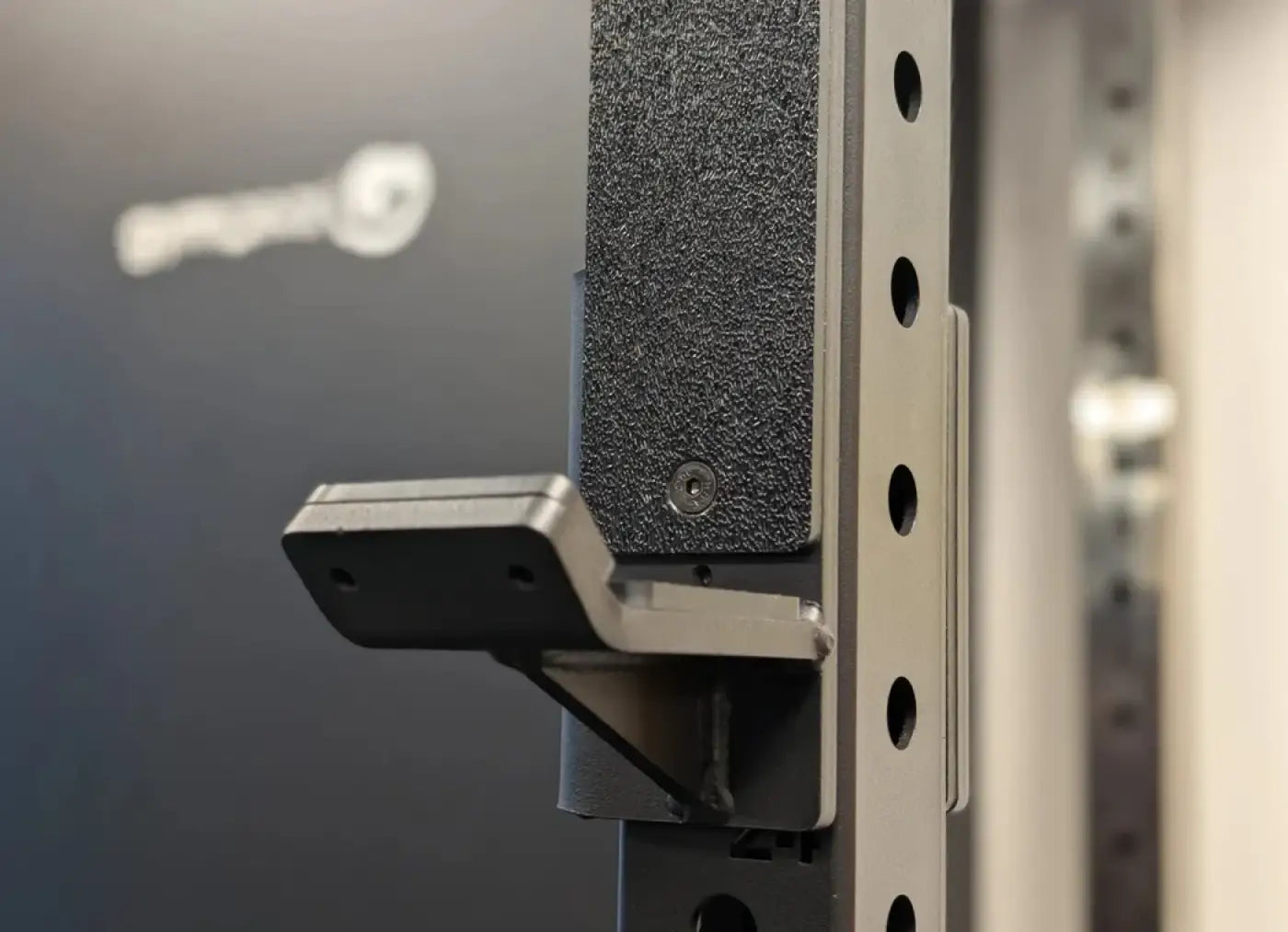 Black textured rubber grip on silver metal bracket of rhino compact dual adjustable pulley folding half rack
