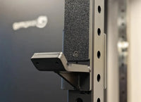Black textured rubber grip on silver metal bracket of rhino compact dual adjustable pulley folding half rack
