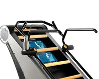 Black and silver StairMaster Jacobs Ladder X treadmill with wooden handrails and digital display showing exercise animations