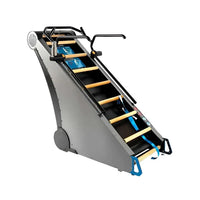 Gray metal StairMaster Jacobs Ladder X stair climber with wooden steps and black handrails shown from the back side