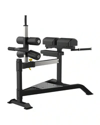 Black and silver adjustable Sterling Series glute ham bench with padded seat handlebars and weight plates for UK delivery