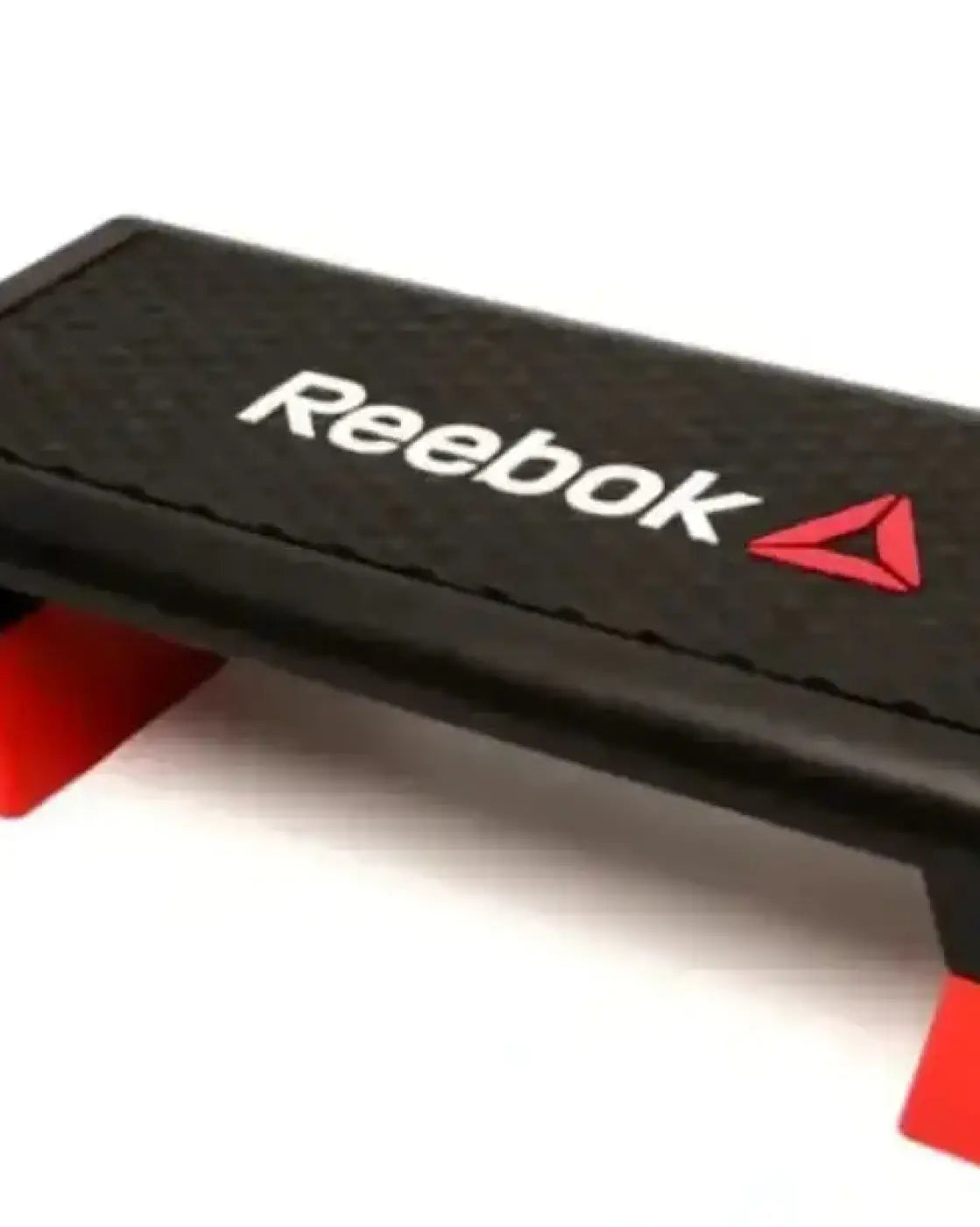 The Reebok Step home gym exercise step with black textured surface and red plastic feet for fitness workouts